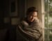 woman cuddling blanket