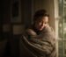 woman cuddling blanket
