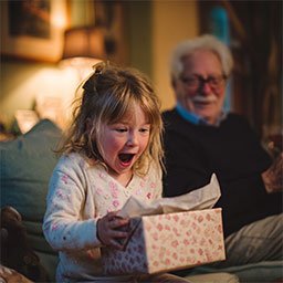 Little girl opening present